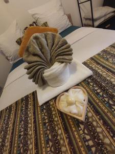 a hat and a bowl of food on a bed at O'me Wally in Galargues +2 photos