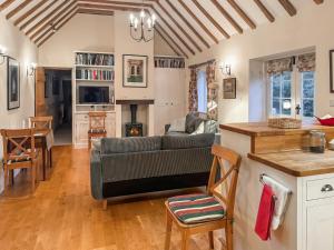 a living room with a couch and a table at Leacon Hall Lodge in Orlestone
