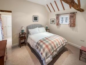 a bedroom with a bed and two tables and a window at Leacon Hall Lodge in Orlestone +14 photos