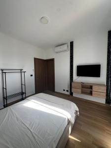a bedroom with a bed and a flat screen tv at Los Magicos Apartments, Punta Cana in Punta Cana +9 photos