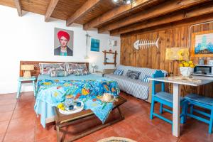 a bedroom with a bed and a table and a couch at Cabin in front of idyllic majanicho beach in Majanicho