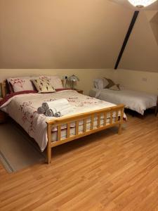 a bedroom with a bed with a wooden frame at Squirrel View Cottage B&B in Buckenham