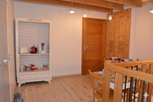 a living room with a table and a wooden floor at Joz Une Halte in Saint-Antoine +16 photos