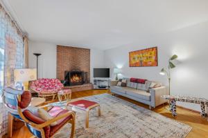 a living room with a couch and a fireplace at Castle View - Wifi, Pet Friendly, Screen Porch, Game Room, Grill, Family Friendly, Kid Friendly, Fireplace in Berkeley Springs