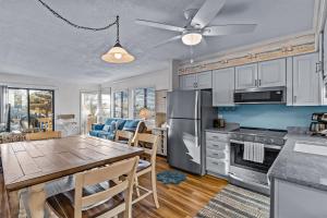 a kitchen and dining room with a table and a dining room at OIB34 OIB Isle Retreat in Ocean Isle Beach