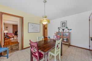 a dining room with a wooden table and chairs at Castle View - Wifi, Pet Friendly, Screen Porch, Game Room, Grill, Family Friendly, Kid Friendly, Fireplace in Berkeley Springs