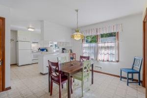 a kitchen and dining room with a table and chairs at Castle View - Wifi, Pet Friendly, Screen Porch, Game Room, Grill, Family Friendly, Kid Friendly, Fireplace in Berkeley Springs