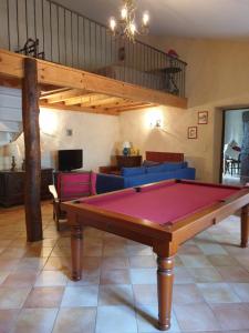 a living room with a pool table in the middle at Studio, chambre d'hôtes dans mas provençal in Sauzet