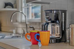 three coffee cups sitting on a kitchen counter at Castle View - Wifi, Pet Friendly, Screen Porch, Game Room, Grill, Family Friendly, Kid Friendly, Fireplace in Berkeley Springs +39 photos