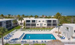 an aerial view of a large building with a swimming pool at Stylish Angler's Retreat, Poolside & Ocean Access #16 in Marathon +28 photos