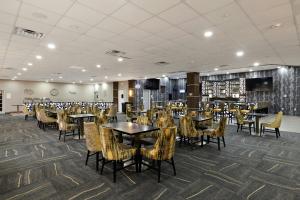 a restaurant with tables and chairs in a room at Verta Hotel McAllen in McAllen
