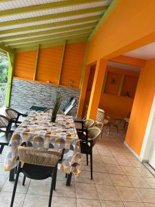 a room with a table and chairs on a patio at Milles Eclats in Les Anses-dʼArlets