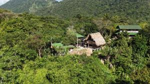 an aerial view of a house in the forest at Siwi Lodge in Cañaveral