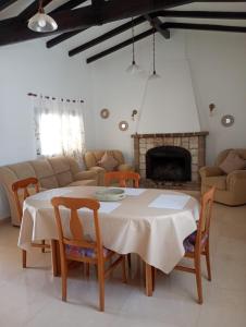 a living room with a table and a fireplace at Departamentos Elisabeth in Tanti