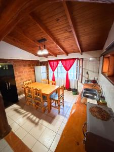 a kitchen with a table and chairs in a kitchen at Complejo turístico Paraíso Escondido in Lago Puelo