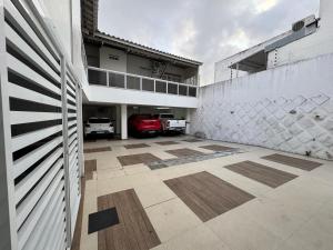 a garage with a car parked inside of a building at Pousada Hospedar Imperial in Campina Grande