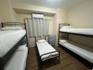 a room with three bunk beds and a window at Paloma in Athens +14 photos