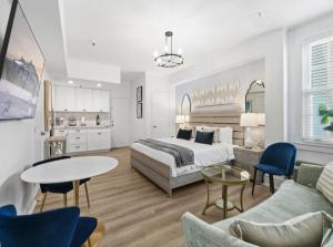 a bedroom with a bed and a living room at Tropicals of Palm Beach in Palm Beach