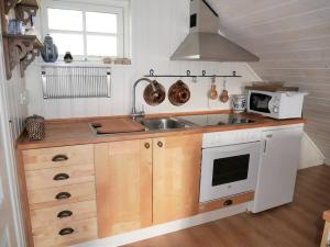 a kitchen with a sink and a microwave at Apartment at Prästtorp in Brastad