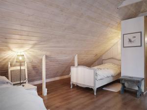a attic bedroom with a bed and a table at Apartment at Prästtorp in Brastad