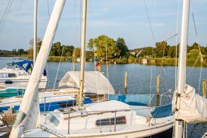 a boat docked at a dock in the water at Apartment in Morgenitz - Insel Usedom 3207 in Morgenitz
