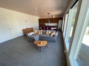 a living room with a couch and a table at Lakeside Cottages in Rastinniemi