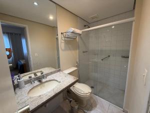 a bathroom with a sink and a toilet and a shower at Hotel Flat Biena Parque Ibirapuera 810 incluso estacionamento in São Paulo