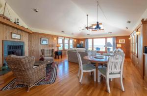 a living room with a table and chairs at Run-A-Way Bay - Duck, Sanderling, Oceanfront, Ocean View, Hot Tub, Community Pool, Tennis in Duck