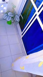 a room with a bed and a glass door at Phee home in Mombasa