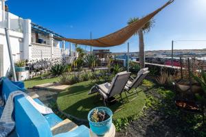 a patio with two chairs and a hammock at Beachfront two bedrooms house Casa Toral in Majanicho