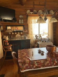 a dining room with a table and a kitchen at The Canyon Wren in Bluff