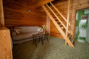 a room with a couch and a table and a staircase at Hotel Sjever in Šavnik