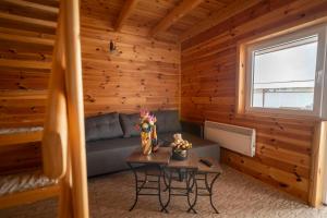 a living room with a couch and a table at Hotel Sjever in Šavnik +28 photos