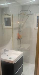 a white bathroom with a sink and a shower at Aurora in Montauroux +3 photos