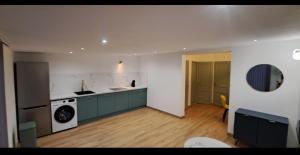 a kitchen with green cabinets and a washer and dryer at Aurora in Montauroux