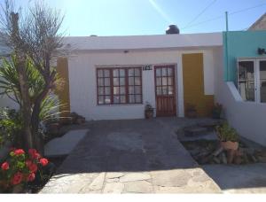 a small white house with a tree in front of it at Lo de Nilda in Playa Unión