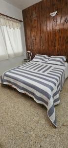 a bedroom with a black and white striped bed at Lo de Nilda in Playa Unión