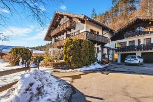a house with a car parked in front of it at Gaestehaus Florian - Ferienwohnungen in Grainau