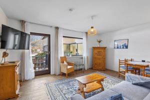 a living room with a couch and a table at Gaestehaus Florian - Ferienwohnungen in Grainau