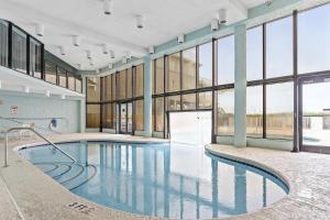 a swimming pool in a building with large windows at OIB74 Kat Cove 2 in Ocean Isle Beach