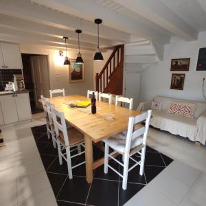 a kitchen and dining room with a wooden table and chairs at The Magnolia in Skopelos Town