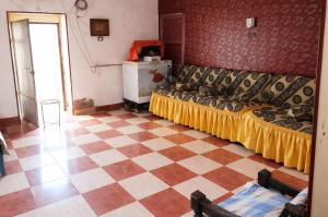 a bedroom with a couch and a checkered floor at Mostafa Gest House in Asyut +10 photos