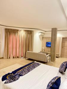 a hotel room with two beds and a couch at SAAFI Boutique Hotel in Abuja +39 photos