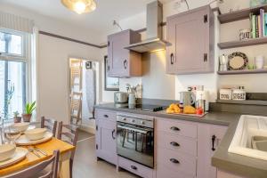 a kitchen with white cabinets and a table and a sink at 2 Bed in Cromer oc-t29986 in Cromer