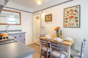 a kitchen and dining room with a table and chairs at 2 Bed in Cromer oc-t29986 in Cromer +8 photos