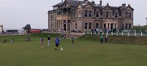 a group of people playing golf in front of a castle at Rooms by the Lade Braes & Doocot in St Andrews in St. Andrews
