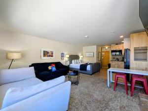 a living room with a couch and a table at Edgewater 1436 by SummitCove Lodging in Colorado in Keystone