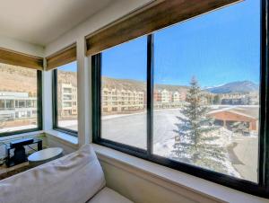 a room with a couch and a large window at Edgewater 1436 by SummitCove Lodging in Colorado in Keystone