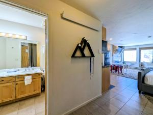 a bathroom with a sink and a mirror at Edgewater 1436 by SummitCove Lodging in Colorado in Keystone +30 photos
