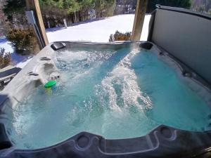 a jacuzzi tub with water in the snow at Westcott House- Privacy, amenities and space all in one beautiful package! in Luray